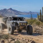 Off-road race vehicle crossing rugged Baja California Sur desert terrain