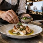 Chef plating a Baja-inspired dish for a Los Cabos culinary event